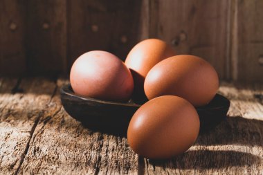 pile of eggs on rustic wood, close-up image