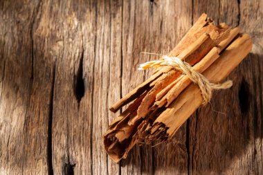cinnamon chips on rustic wood, close-up view