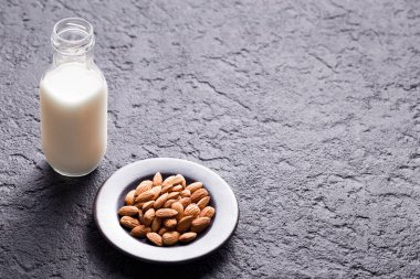 milk and almond seeds (Prunus dulcis) close-up image
