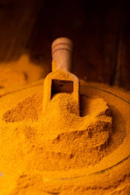 Tahta kaşık ve kase içinde zerdeçal tozu