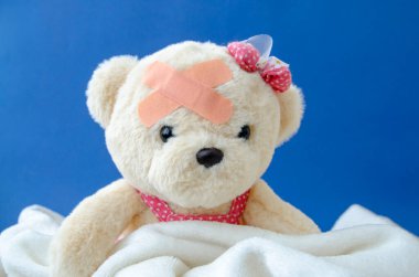 Child injury prevention. Toy bear with a medical bandage