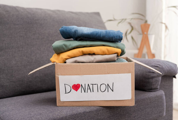 Cardboard donation box full of clothes is ready for giving to charity
