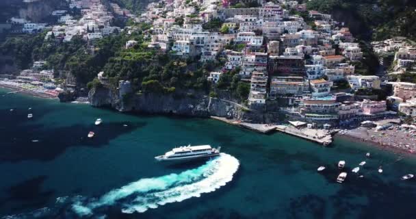 当地的渡船抵达城市 可以看到停泊的帆船和游艇 在意大利那不勒斯海岸的阿马尔菲海岸湾停泊的游艇和小艇的空中图片 轮渡运输 — 图库视频影像