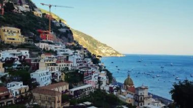 Positano, tourist destination on the Amalfi Coast, Historic White town along the Amalfi Coast Near Salerno. Aerial view of the famous tourist resort of the Amalfi coast. Blue Ocean with boats. 