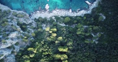 Top down aerial shot of incredible clear and turquoise water in the Mediterranean Sea With rocky coastline and boats in water at Blue Lagoon . Turquoise blue water sea with yacht sail.