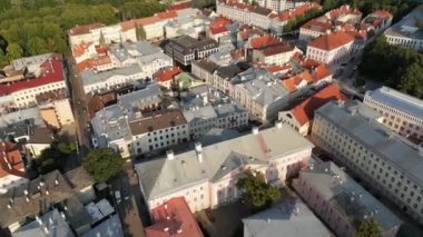 Morning drone view of town hall with amazing sunrise sunset view. Tartu scenic summer aerial view of the Old Town pier architecture. Aerial view of the medieval town. Estonia. Panoramic Skyline 