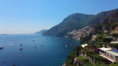Positano, tourist destination on the Amalfi Coast, aerial time lapse hyper lapse view. Aerial Drone View of Positano near Naples, Italy. Famous Mediterranean resort turquoise sea Blue Ocean with boats