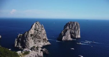 Aerial view of the three Faraglioni rocks off the Capri island. Aerial drone view of the Tyrrhenian sea coast of Capri, Italy. Coastal of azure Tyrrhenian Sea, Capri, island of Gulf of Naples, Italy.