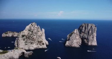 Aerial view of the three Faraglioni rocks off the Capri island. Aerial drone view of the Tyrrhenian sea coast of Capri, Italy. Coastal of azure Tyrrhenian Sea, Capri, island of Gulf of Naples, Italy. 