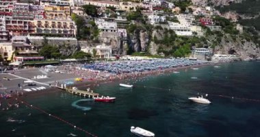 Positano, tourist destination on the Amalfi Coast, aerial view. Aerial Drone View of Positano near Naples, Italy. Famous Mediterranean resort turquoise sea Blue Ocean with boats. Resort paradise coast