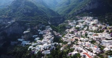 Positano, tourist destination on the Amalfi Coast, aerial view. Aerial Drone View of Positano near Naples, Italy. Famous Mediterranean resort turquoise sea Blue Ocean with boats. Resort paradise coast
