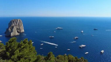 Timelapse view of the three Faraglioni rocks off the Capri island. Aerial drone view of the Tyrrhenian sea coast of Capri, Italy. Coastal of azure Tyrrhenian Sea, Capri, island of Gulf of Naples Italy