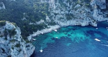 Aerial view of the three Faraglioni rocks off the Capri island. Aerial drone view of the Tyrrhenian sea coast of Capri, Italy. Coastal of azure Tyrrhenian Sea, Capri, island of Gulf of Naples, Italy.