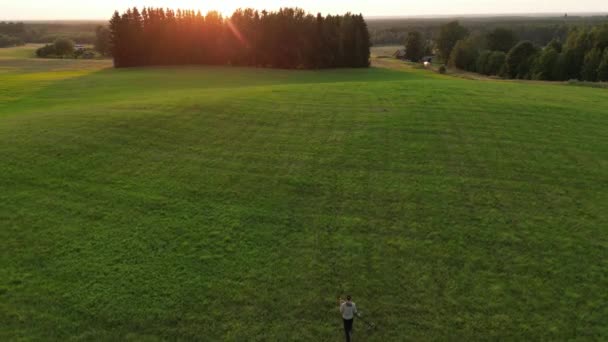 Aerial View Flying Metal Detector Man Field Sunset Walking Alone — Video Stock