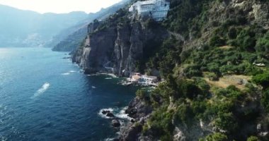 Positano, tourist destination on the Amalfi Coast, aerial time lapse hyper lapse view. Aerial Drone View of Positano near Naples, Italy. Famous Mediterranean resort turquoise sea Blue Ocean with boats