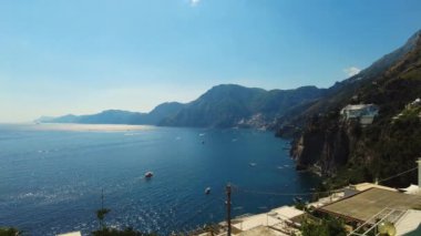 Positano, tourist destination on the Amalfi Coast, aerial time lapse hyper lapse view. Aerial Drone View of Positano near Naples, Italy. Famous Mediterranean resort turquoise sea Blue Ocean with boats