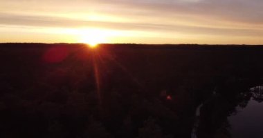 Mystical old wooden trail road in the fog. Walking along a wooden pathway in a bog swamp. Sunrise rays shining through, Sun shining through fog mist. Sunrise in Misty Countryside. Magical Fog Horizon.