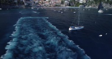 Turquoise blue water sea with yacht sail with sunset. Aerial top down view of a boat on a mediterranean sea. One ship boat in beautiful nature ocean landscape. Motor boat moving over the deep blue sea