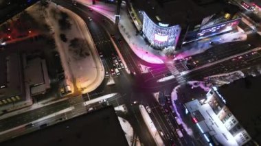 Top down aerial of cars drive at cross road. Heavy traffic in downtown streets. Pedestrians crossing busy intersection. Traffic highway transportation. Fast moving cars, trucks, buses and trains. 