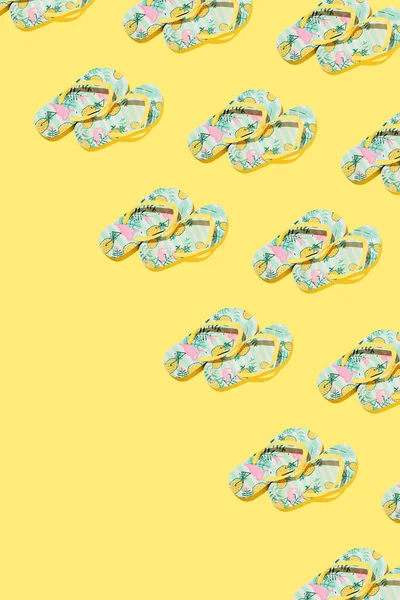 stock image Flip flops illustrated with pineapples and pink flamingos on bright yellow background. Minimal summer tropical vacation concept with copy space.