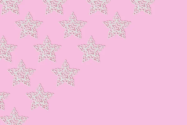 White ornament star on pink background. Christmas composition. Holiday pattern. Copy space.