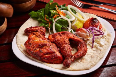Ekmek, salata ve limonlu ızgara Tandır Tavuğu. Orta Doğu yemekleri masasının yanında servis edilir.