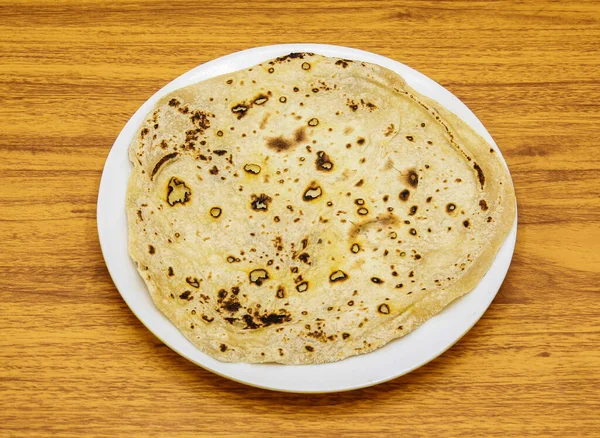 Premium Photo  Tawa chapati roti served in plate isolated on table top  view of indian and pakistani spicy food