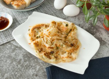 Scallion Pancake Original Flavor with egg and sauce served in dish isolated on napkin top view on table taiwan food