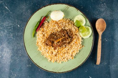 spicy beef pulao, polao, biryani, mandi, kacchi with egg and salad served in dish isolated on table top view of indian food