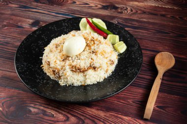 spicy Egg pulao, polao, biryani, mandi, kacchi with egg and salad served in dish isolated on table top view of indian food