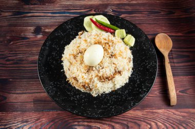 spicy Egg pulao, polao, biryani, mandi, kacchi with egg and salad served in dish isolated on table top view of indian food