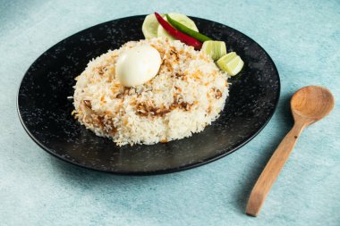 spicy Egg pulao, polao, biryani, mandi, kacchi with egg and salad served in dish isolated on table top view of indian food