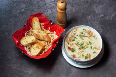 Cream of Mushroom Soup with garlic bread served in bowl isolated on grey background top view of indian and bangladesh food