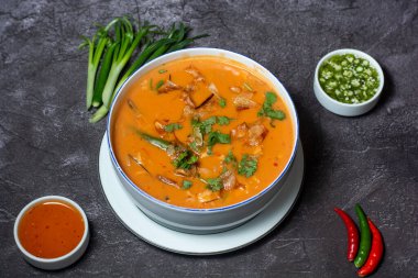 Special Thai Soup with green pepper and sauce served in bowl isolated on grey background top view of indian and bangladesh food