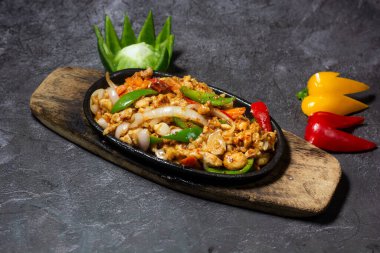 Chicken sizzling served in dish isolated on grey background top view of indian and bangladesh food