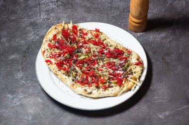 Black Cream Naan with pomegranate seeds and cherry tomato served in dish isolated on grey background top view of indian and bangladesh food