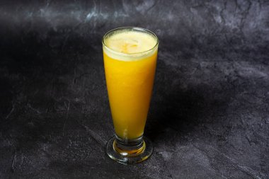 Mixed Fruit Juice of papaya, pineapple, and orange served in glass isolated on grey background top view of indian and bangladesh food