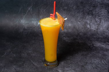 Fresh Orange Juice with straw served in glass isolated on grey background top view of indian and bangladesh food