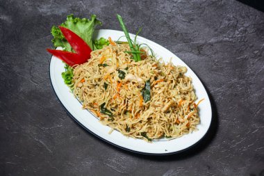 Chicken Chowmein served in dish isolated on grey background top view of indian and bangladesh food