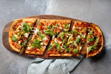 Vegeterian Pizza with pomegrnate seeds served in wooden board isolated on table top view of arabic breakfast clipart