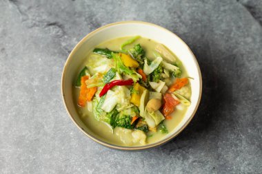 Yeşil Köri Sebzeleri, arka planda yalıtılmış bir şekilde servis edilir. Bangladeş yemeklerinin üst görüntüsü.