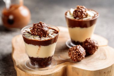 Ferrero rocher cheesecake ahşap pano manzaralı kafede servis edilir peynirli pasta tatlısı