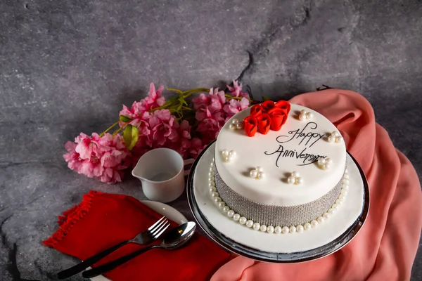 Happy anniversary White Pearl Cake or women day and valentine celebration with flowers, spoon and fork served on board isolated on napkin side view of cafe bake food