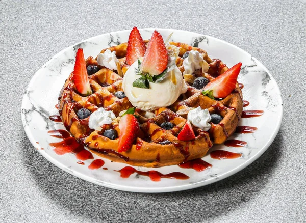 Mixed Berry Waffle with strawberry, blueberry and ice cream served in dish isolated on background top view of hong kong dessert food