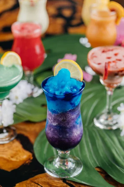 Blue Hawaiian lagoon ice drink with lime slice served in glass isolated on table side view of healthy morning arabic drink