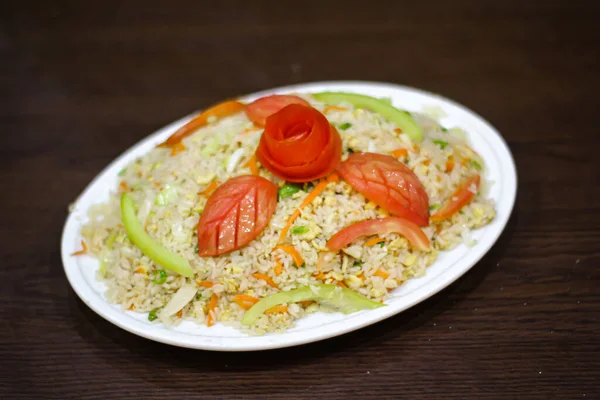 Veg and egg fried rice served in dish isolated on table side view of chinese spices food