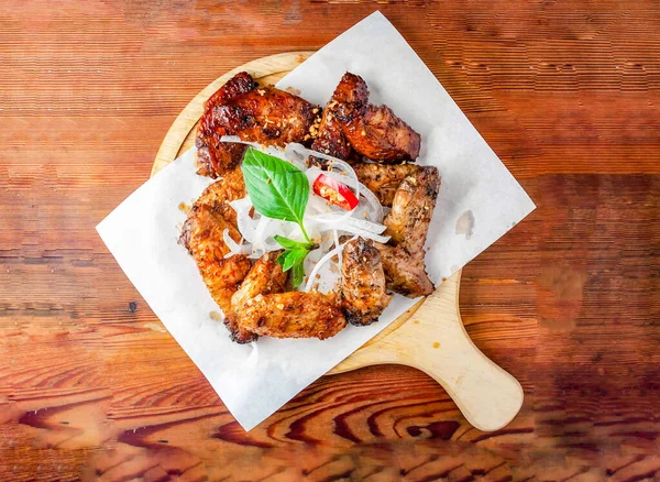 fried wings platter 12 pcs served on cutting board isolated on wooden table top view of hong kong food