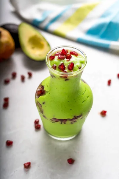 Fresh Avocado shake with Pomegranate seeds served in jar isolated on table top view of arabic food