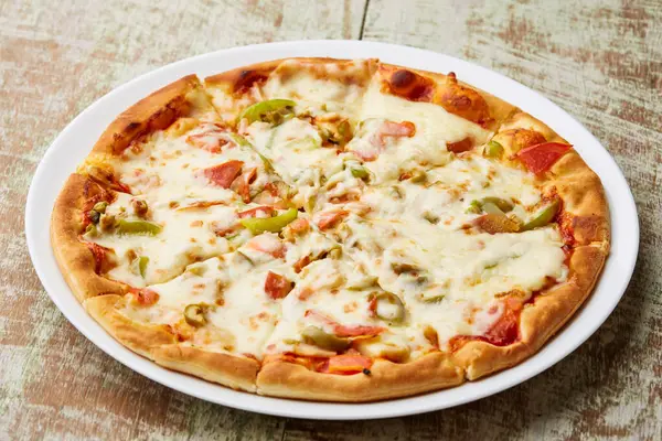 Vegetable Pizza include bell pepper, mushroom, tomato and onion served in dish isolated on table top view of arabic food