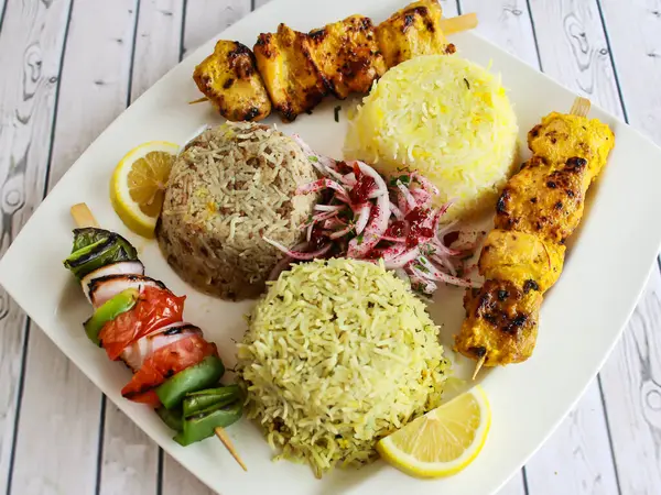 stock image Chicken Joojeh Kebab Rice with onion, lemon served in dish isolated on table closeup top vie of arabic spicy food